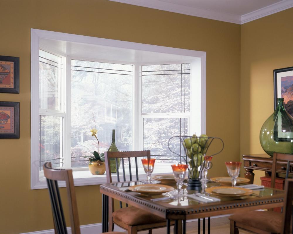 Bay and bow window showcases winterscape from dining room.